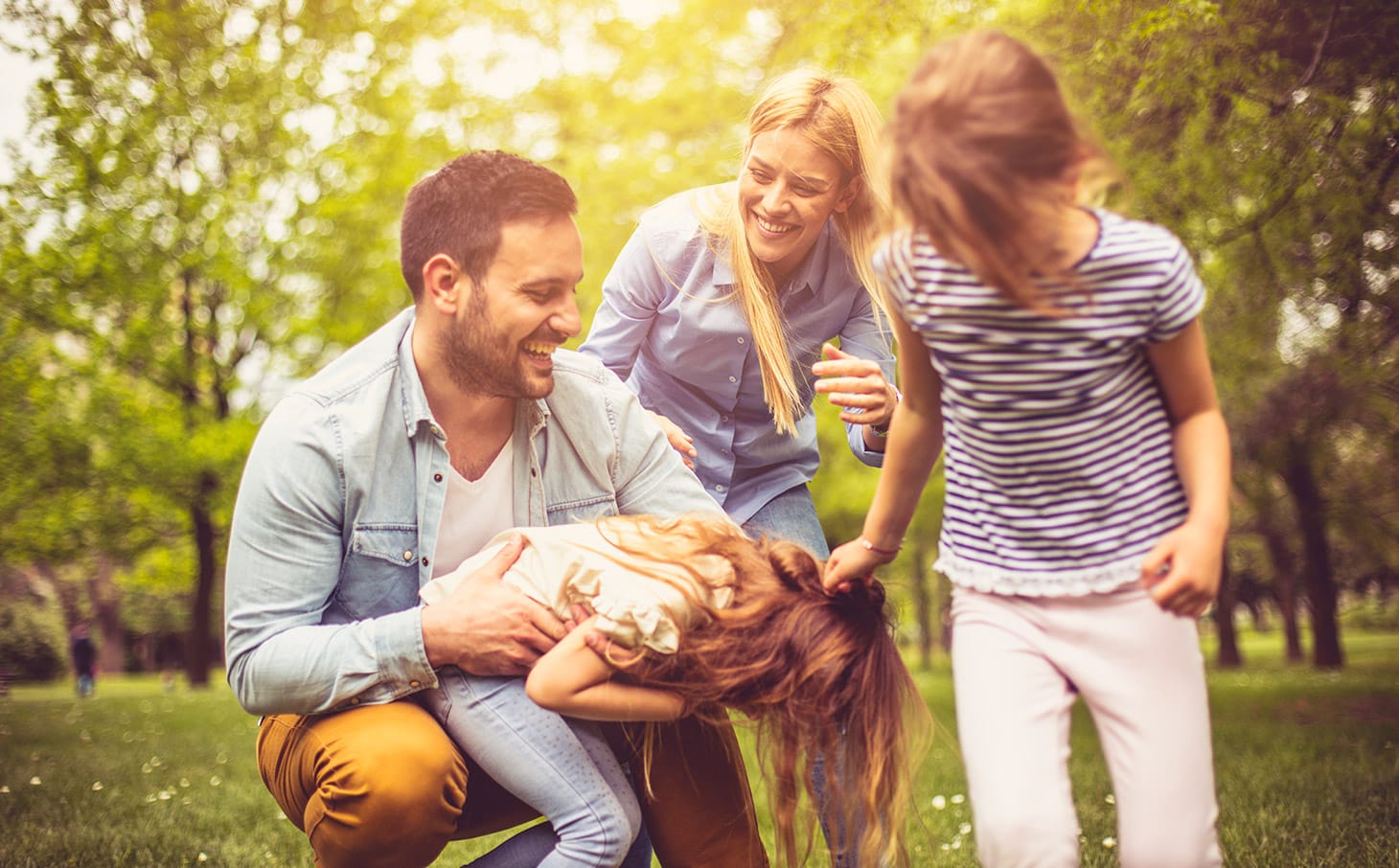 A happy family playing at the park